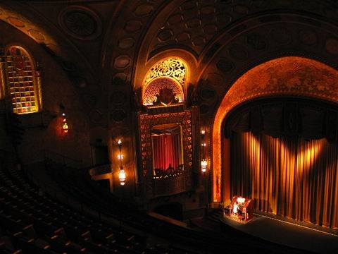 An organist practicing, as viewed from the theatre balcony